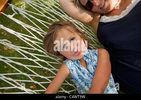 USA,Idaho,Portrait of girl (4-5) with mother in hammock Stock Photo