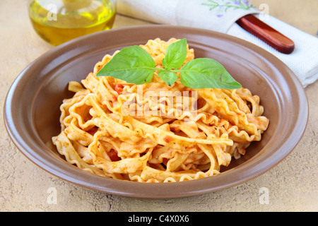 Italian pasta tripoline with tomato sauce and basil Stock Photo - Alamy