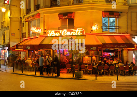 People sitting outside a restaurant in St Germain area of Paris at night Stock Photo