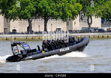 Metropolitan Police high speed Rigid Inflatable Boat and police team passing Tower of London on River Thames Stock Photo