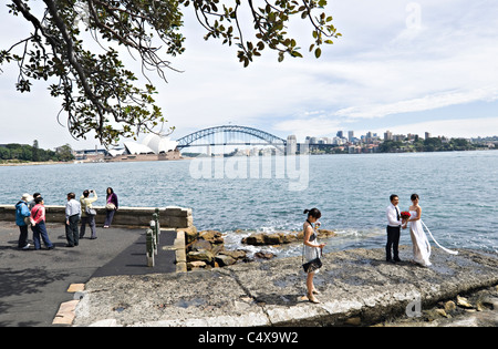 The Sydney Opera House and Harbour Bridge from Mrs Macquaries Point New South Wales Australia with Bride and Groom Photography Stock Photo