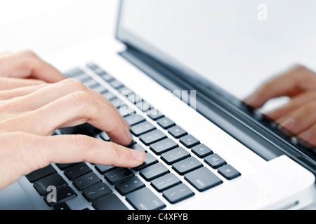 Hands typing on laptop computer keyboard close up Stock Photo