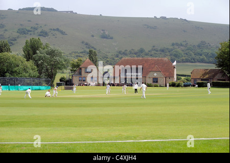 Preston Nomads play hosts to Horsham cricket team at their picturesque ground in Fulking Sussex which is overlooked by the Downs Stock Photo