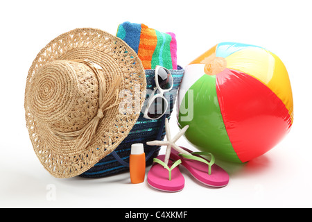 Beach items with straw hat,towel,flip flops,sunblock,beach ball and sunglasses.