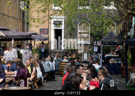 People Eating and Drinking in the Beer Garden in the Vibe Bar, Brick Lane, London Stock Photo