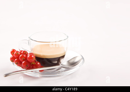 photo of espresso with currant in glass cup on white isolated background Stock Photo