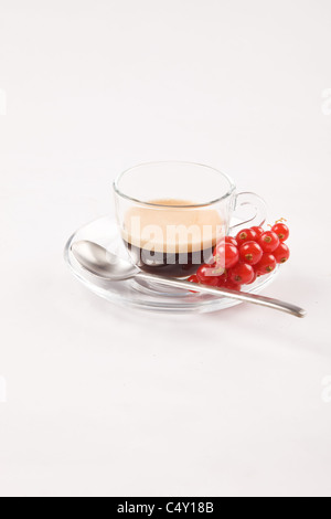 photo of espresso with currant in glass cup on white isolated background Stock Photo