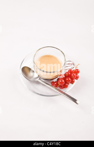 photo of espresso with currant in glass cup on white isolated background Stock Photo