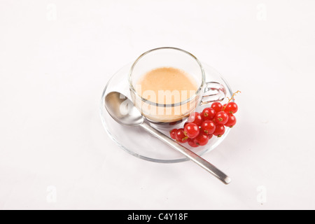 photo of espresso with currant in glass cup on white isolated background Stock Photo