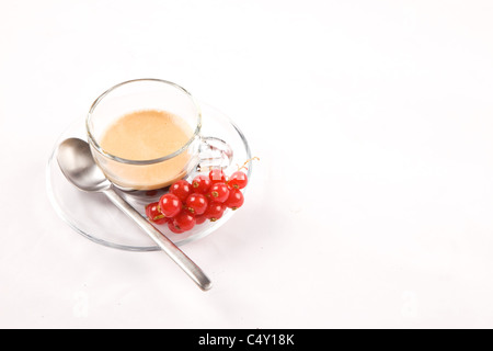 photo of espresso with currant in glass cup on white isolated background Stock Photo