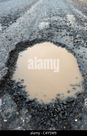 Pothole on Britain's roads during the severe winter of 2010/11 Stock Photo