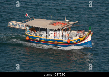 Tourism in Malta. Maltese luzzu converted as a harbour tour boat. Holiday travel in the Mediterranean. Stock Photo