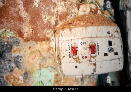 Old unsafe electrical cooker isolation box and socket Stock Photo