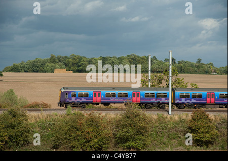 Class 319 train in First Capital Connect livery travelling through the English countryside on the Midland Mainline. Stock Photo