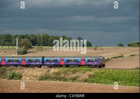 Class 319 train in First Capital Connect livery travelling through the English countryside on the Midland Mainline. Stock Photo