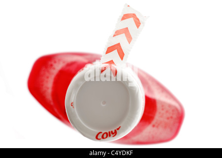 Broken seal on the top of bottle of red mouthwash Stock Photo