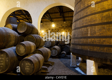 wooden casks of different sizes hold Port fortified wine to mature in wine cellars in Villa Nova de Gaia, Portugal Stock Photo