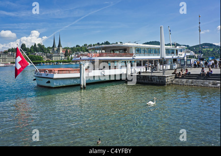 Swiss Motor Cruise Ship Waldstätter is moored in Lucerne on the Lake Lucerne with passengers on the pier boarding. Stock Photo
