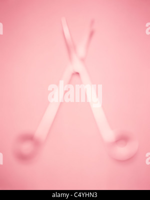 Metal surgical scissors on a pink background with soft selective focus Stock Photo
