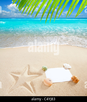 blank paper on white sand beach with shells and starfish print like a summer vacation concept Stock Photo