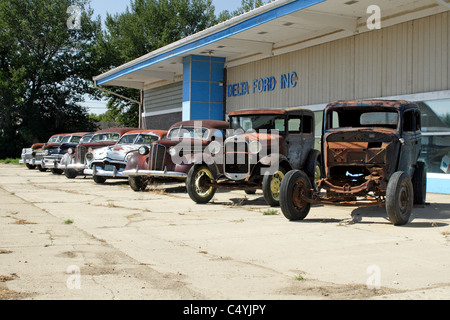 Vintage autos lined up outside a closed Ford dealership in Malta, Montana. Stock Photo