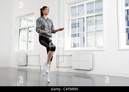 Young Woman Running in Place Stock Photo