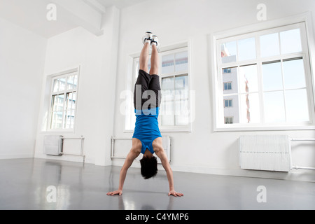 Young Man Doing Handstand Stock Photo