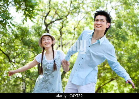 Happy Couple Walking Through the Park Stock Photo