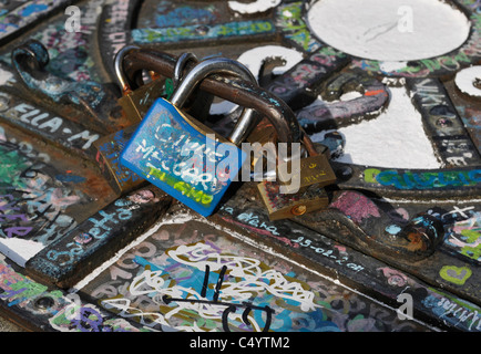 padlocks as symbol of love and friendship on cover of water well - Italy Stock Photo