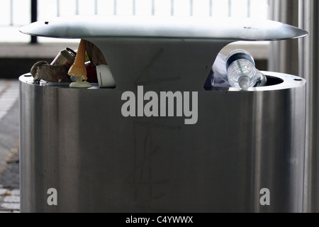 Twi sides of a waste bin full of waste on the embankment of the River Thames, London, England Stock Photo