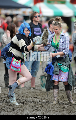 Two girls in the mud at the Glastonbury Festival 2011 Stock Photo