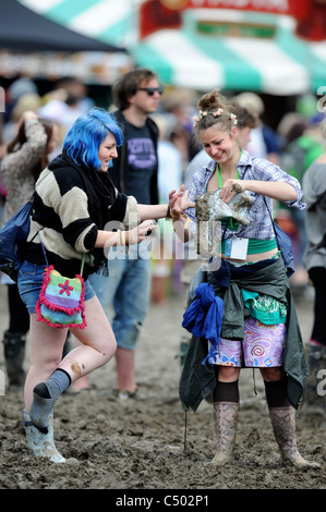 Two girls in the mud at the Glastonbury Festival 2011 Stock Photo