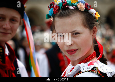 A beautiful girl in traditional Krakow style folklore costume during an ethnographic performance. Stock Photo