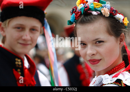 A beautiful girl in traditional Krakow style folklore costume during an ethnographic performance. Stock Photo