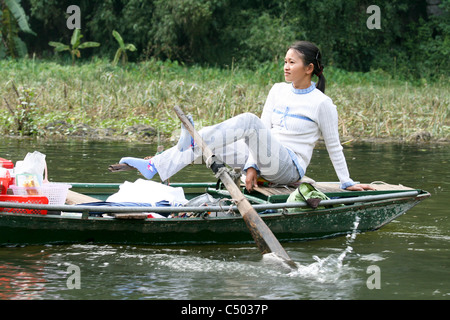 foot rowing Tam Coc area of Ngo Dong River near Ninh Binh, Vietnam Stock Photo