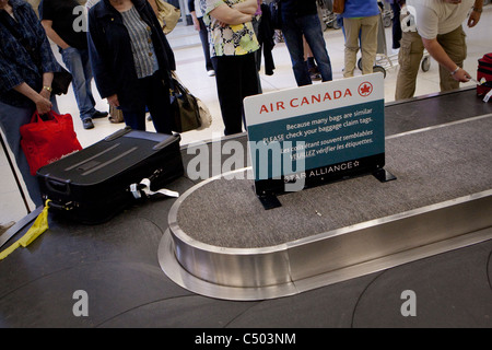 Luggage circles on the baggage carousel at the Winnipeg James Armstrong Richardson International Airport Sunday May 22, 2011. Stock Photo