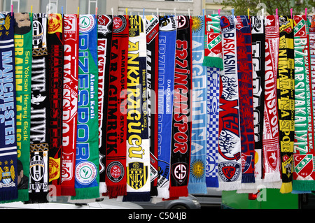 Colorful scarfs as merchandise of Turkish and European football clubs hanging for sale by the wayside in Istanbul,Turkey Stock Photo