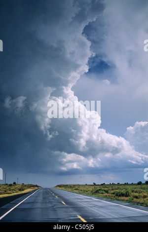 Thunderstorm clouds (cumulonimbus) over road in the Coconino Plateau, near the Grand Canyon, ARIZONA Stock Photo