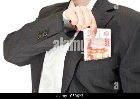 Businessman puts a pile of money in the pocket of his suit. Isolated on white background Stock Photo
