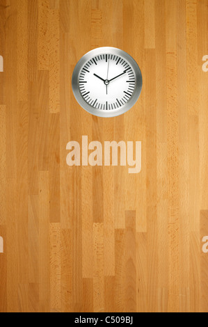 A wall clock in a work place scene Stock Photo