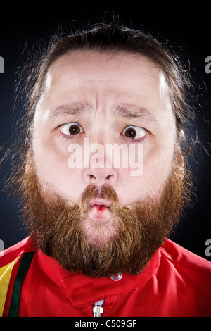 Bearded man puckering his mouth Stock Photo