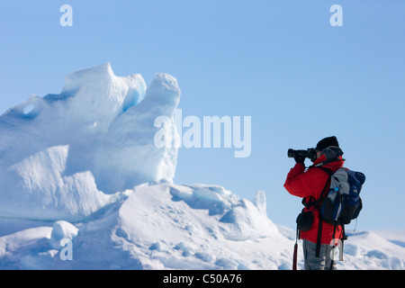 Tourist photographing iceberg, Snow Hill Island, Antarctica Stock Photo