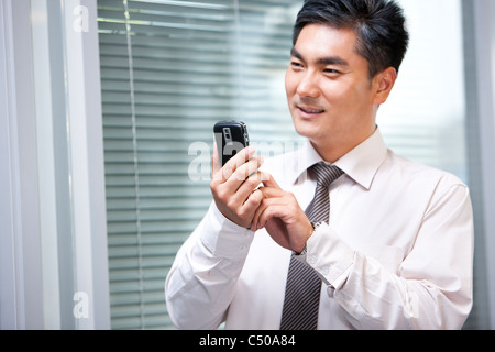 Confident Businessman Sending Text Message Stock Photo