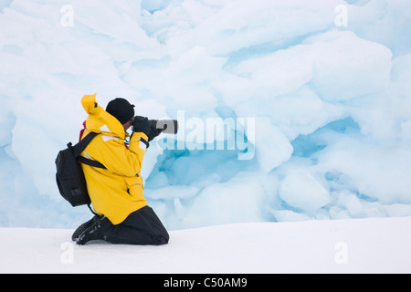 Tourist photographing iceberg, Snow Hill Island, Antarctica Stock Photo