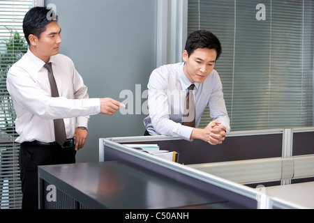 Business Executive Reprimanding Young Businessman Stock Photo