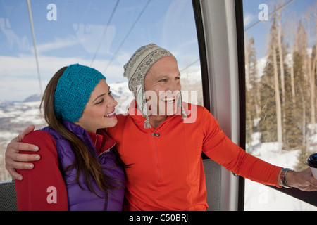 Couple riding in ski gondola together Stock Photo