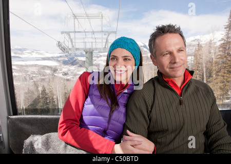 Couple riding in ski gondola together Stock Photo