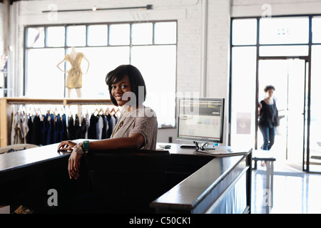 African American woman working in clothing store Stock Photo