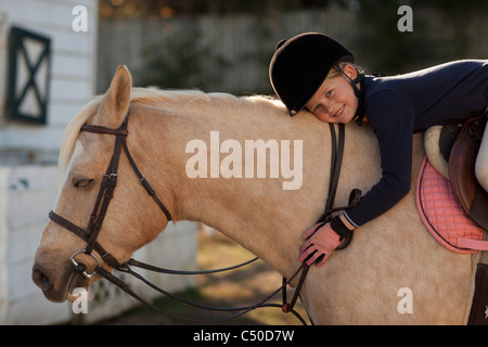 Caucasian girl riding on horse Stock Photo