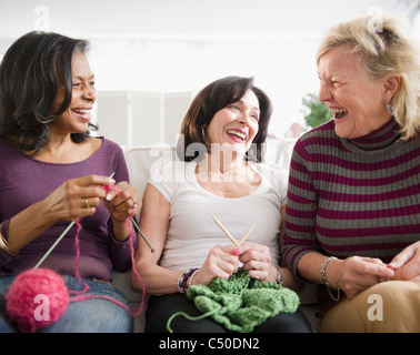 Friends laughing and knitting together Stock Photo